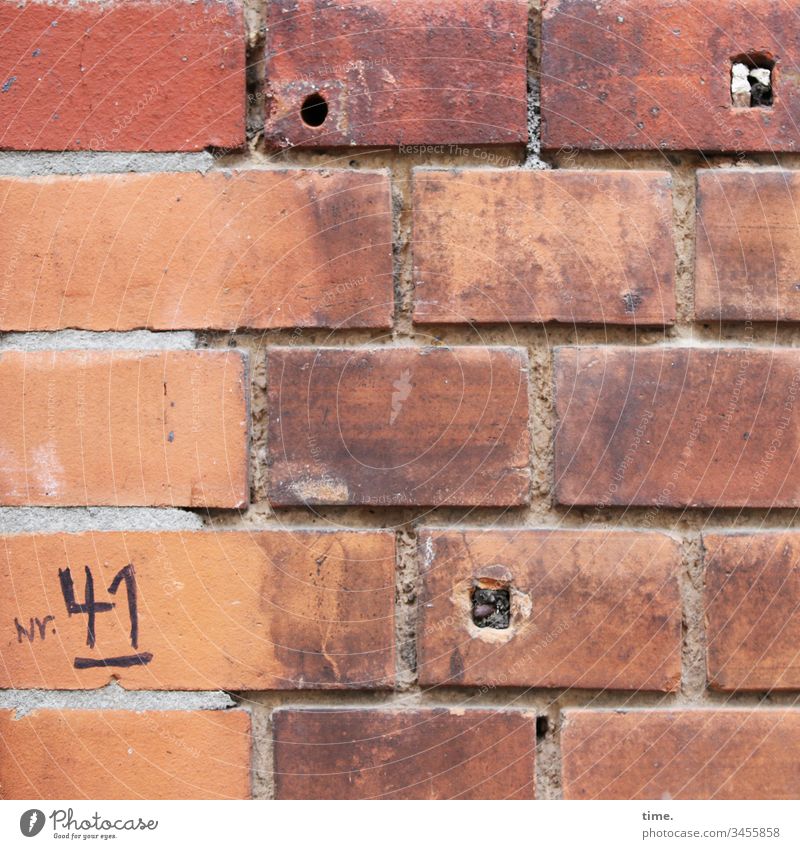 makeshift solution ::: handwritten house number on old badly grouted brick wall with 3 holes House (Residential Structure) Facade urban Stone daylight