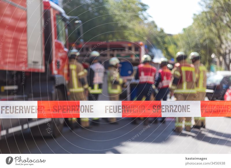 Team of firefighters by firetruck on accident location. equipment rescue protection brigade area site team warning helmet emergency uniform protective