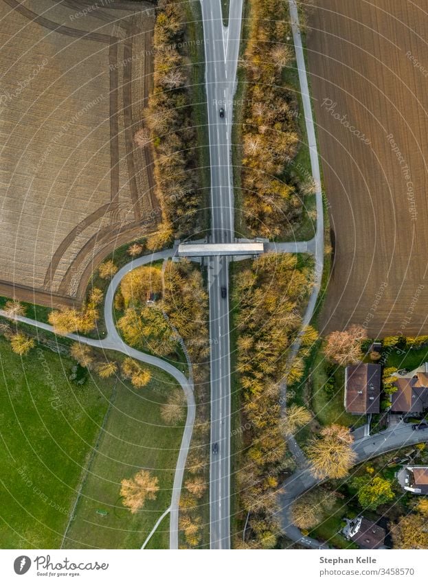 Bird's eye view of a street with a bridge and cars on it, taken with a copter Street Aerial photograph Deserted Exterior shot Day Traffic infrastructure