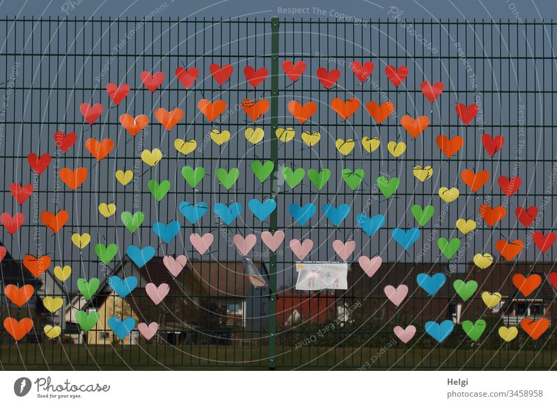 Rainbow against Corona at a fence, consisting of many small colorful hearts, as a sign of solidarity cuddle Multicoloured variegated Solidarity Colour photo