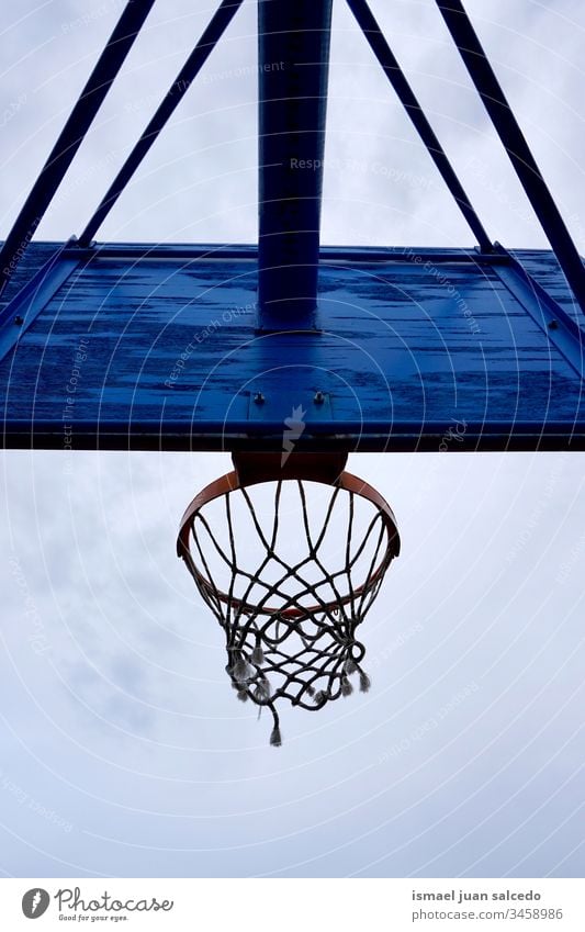 basketball hoop, street basket sky blue silhouette circle chain metallic net sport sports equipment play playing playful old park playground outdoors minimal