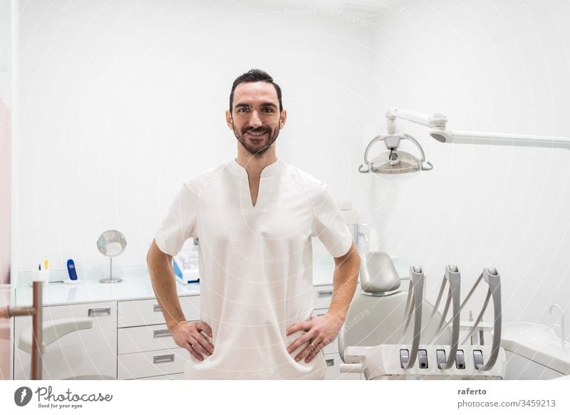 Portrait of a smiling doctor male posing in an dentist office clinic happy portrait health care dental bearded professional dentistry white job hospital