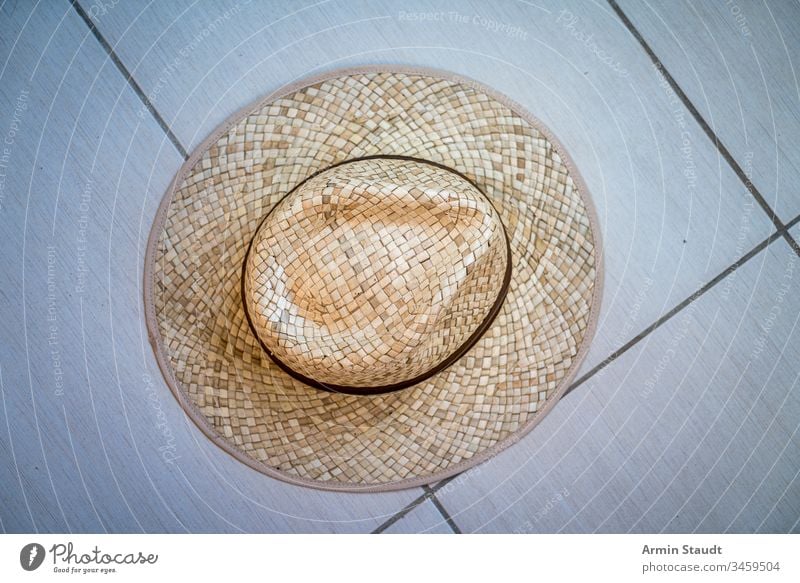 top shot of a straw hat accessory beach brown clothing design fashion floor ground object old one pattern protection retro ribbon shade strawhat style summer