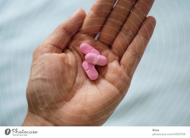A hand with pink pills, medication, pills medicine tablets drugs by hand Human being salubriously Sick Healthy painkillers Medication Painkiller Health care
