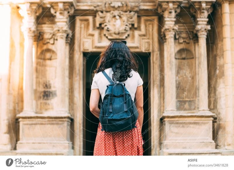 Young tourist woman admirng ancient monuments in Europe travel building church architecture art vacation girl holiday city happy backpack summer spring one