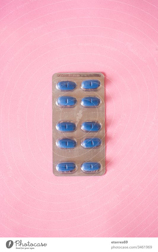 Blue medical pills on pink background COVID-19 analgesic blue care coronavirus drug female hands health holding illness medication medicine painkiller panorama