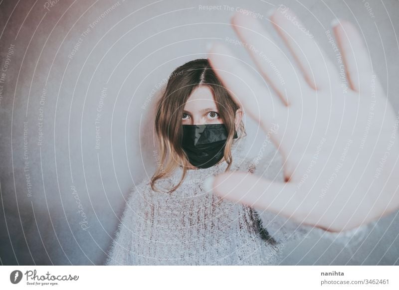 Young woman wearing a mask and put her hand for social distance covid 19 coronavirus breath pandemic illness infected stop contagious infection allergy asthma