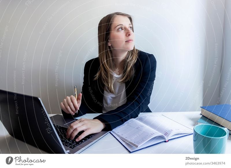 Free Stock Photo of Businesswoman working on laptop in office