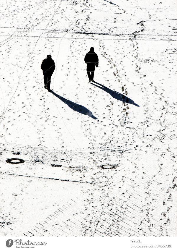 As if cloned and yet strange, the two men trudged past each other in the snow. Snow Winter Places Man Black & white photo Cold Tracks Shadow Sunlight