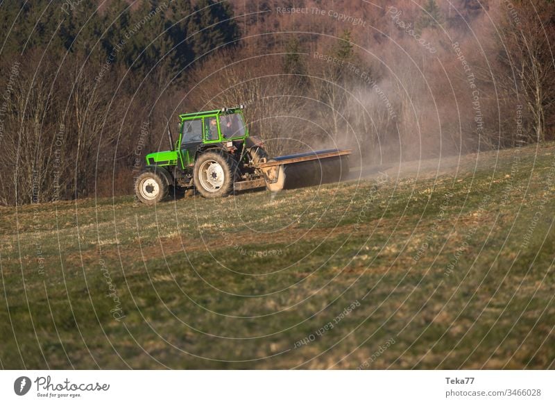 a tractor on a meadow in the evening green tractor modern tractor agricultural agriculture business country countryside cultivate cultivation environment