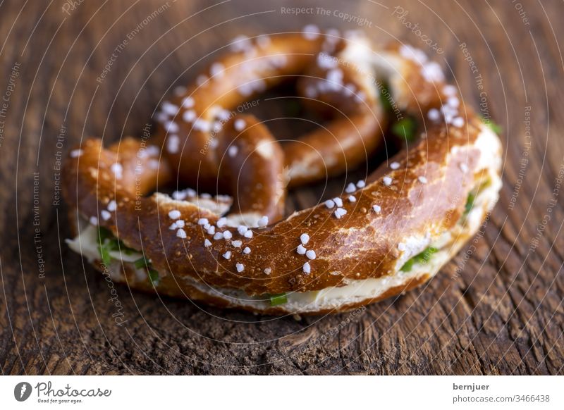 Bavarian pretzel with butter on wood Pretzel Butter Butter pretzel cut spawn Wood Breakfast Oktoberfest Baking Eating Bread Germany traditionally Munich