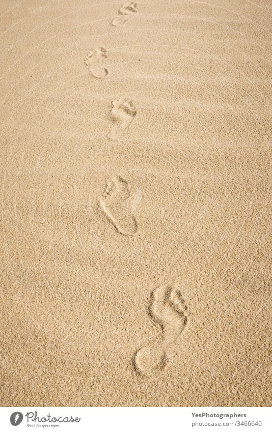 Barefoot footprints on sand. Walk on the beach German beach on one's own background naked feet Beach European island fine sand Footpath footsteps Heat