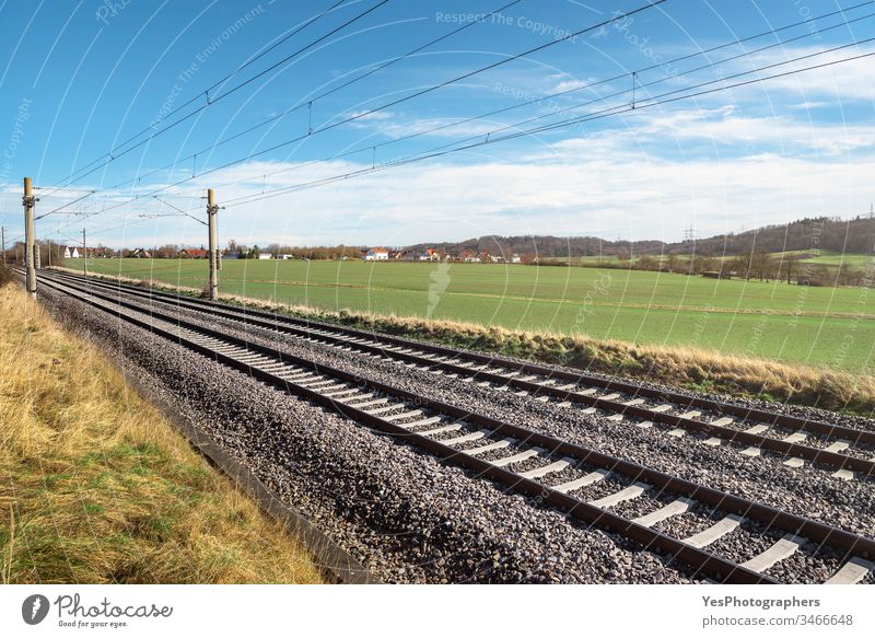 Railroad tracks through green meadow. German rail infrastructure Germany connection direction europe freedom german rail journey landscape logistic nature