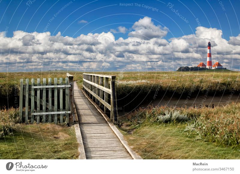 Westerhever Lighthouse Westerhever lighthouse Schleswig-Holstein cloud landscape Clouds in the sky Footbridge Exterior shot marshland Gate Wooden gate out