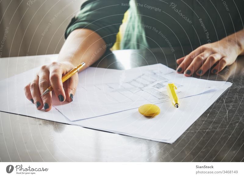 Architect woman sketching in her office business workplace hands desk table working technology notebook view coffee up writing typing internet using female