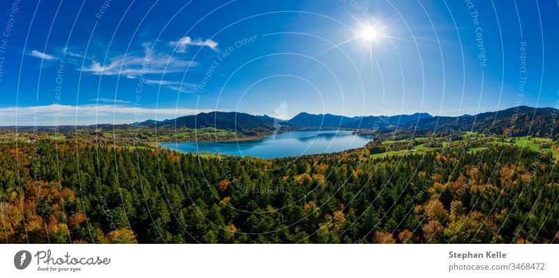 Fantastic panoramic view over the bavarian lake Tegernsee in autumn with fall colors, shot by a drone. mountains nature water sun aerial travel tourism total