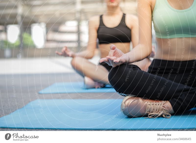 Middle aged woman doing yoga execises in her home garden - a