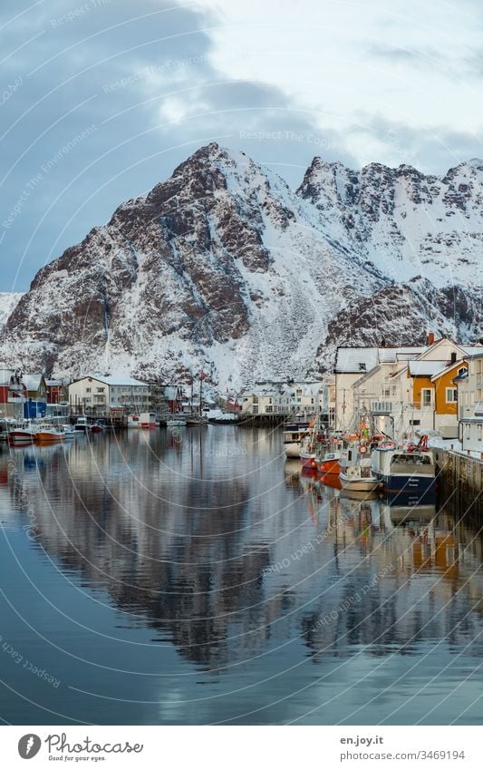 Harbour with boats and houses with reflection in front of snow-covered mountains in Hennigsvaer Henningsvær Lofotes Lofoten Islands Norway Nature Norway 2015