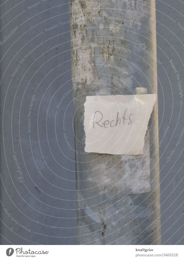 Paper snippets with the inscription "Rechts" glued to a lamppost with two pieces of adhesive film Piece of paper Lamp post Word Letters (alphabet) torn down