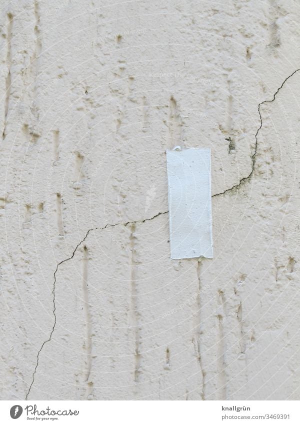 A piece of white adhesive tape over a crack in the plaster of a house wall Adhesive tape Wall (building) Protection Wall (barrier) Facade Plaster pasted over