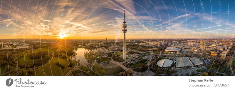 Panoramic aerial view at sunset over Munichs Olympic park. munich olympiapark copy space drone colorful mood evening dawn orange german popular tower tourism