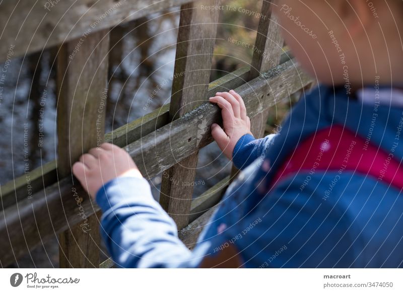 Child holds on to railing corona out girl Playing Handrail kita cordon zooz Fence Nature Forest To go for a walk Discover by hand children's hands