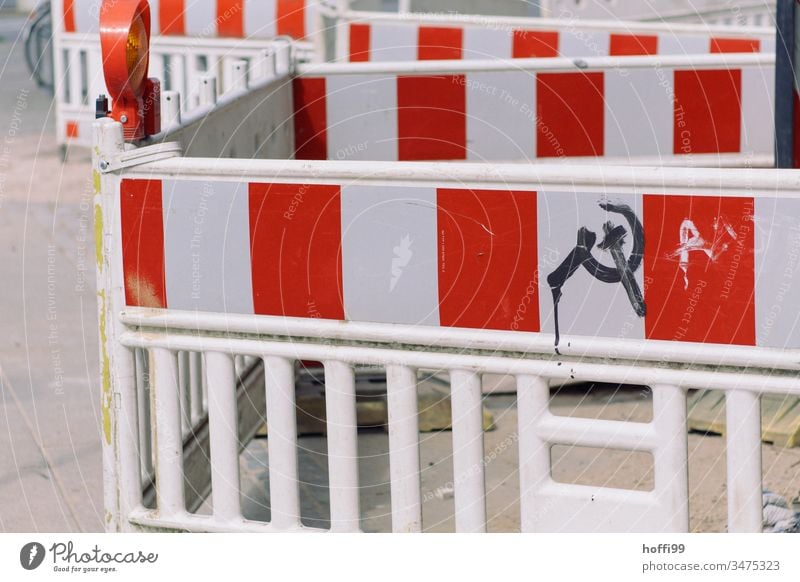 Blocking off construction sites with hammer and sickle symbol Barrier cordon Fence Barque Road construction Construction site Reddish white Repair Protection