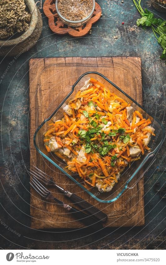 Tasty fish dish with vegetables sauce on kitchen table background with forks. Top view.  Healthy home cooking concept. Homemade cuisine tasty top view healthy