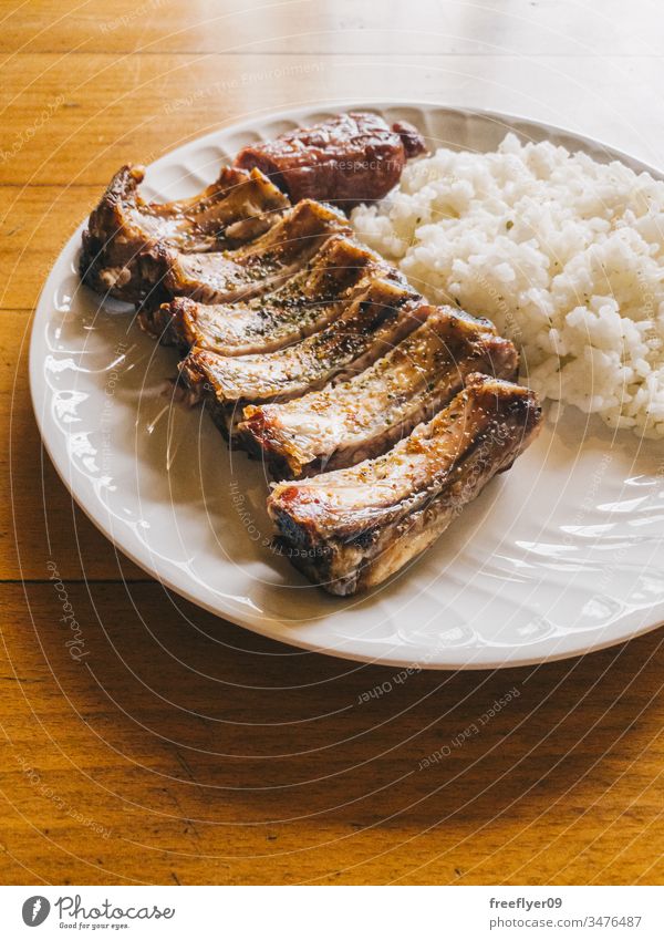 Short ribs with rice and criollo chorizo, typical galician food meat cook bones maple syrup board roasted rip tip barbecue party loin ribs copy space rustic