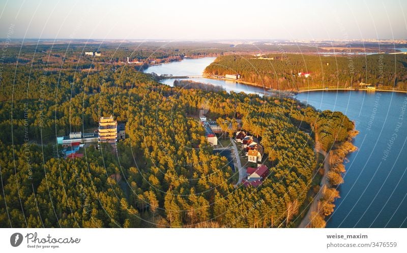Recreation zone and big city aerial view. Riverbank with forest and sanatorium river lake spring shore park lakeside tree water riverbank panorama rural day
