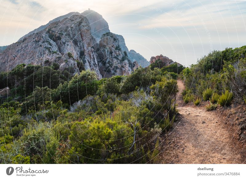 Idyllic hiking trail in the countryside with a view of an imposing mountain rising above the horizon Evening distance Looking Strong already Wellness Discover