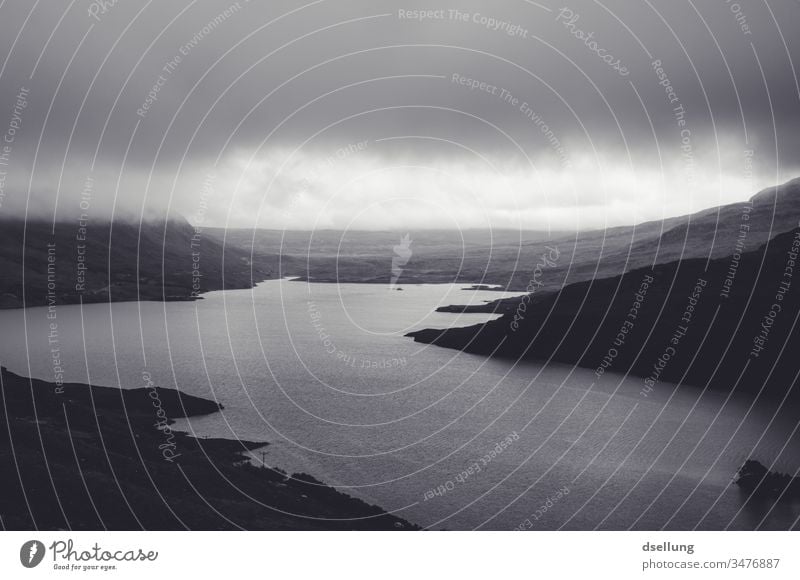 Black and white image of a lake in the Scottish Highlands under cloudy skies Panorama (View) Shadow Light Day Contrast Hollow Scotland Gray Wild natural chill