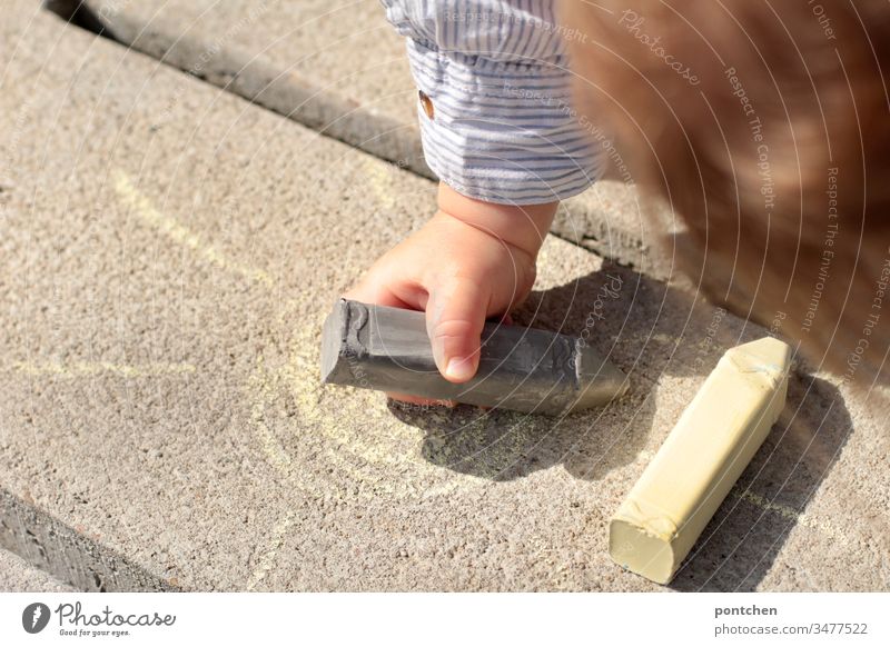 Toddler paints with street chalk. Painting (action, artwork) Children's game Sun Image Leisure and hobbies Colour photo Creativity Chalk Multicoloured