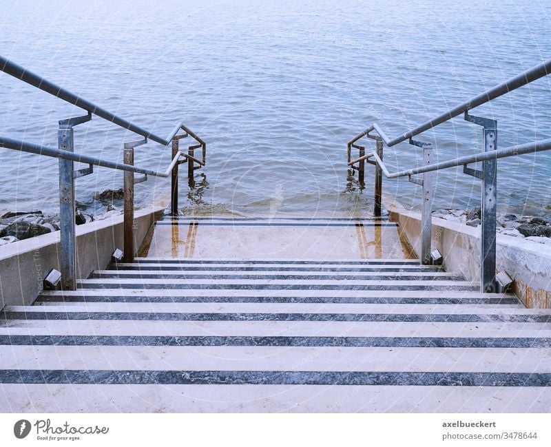 concrete stairs leading into water steps sea ocean staircase stairway river lake descent down blue perspective outdoor nature outdoors nobody coast architecture