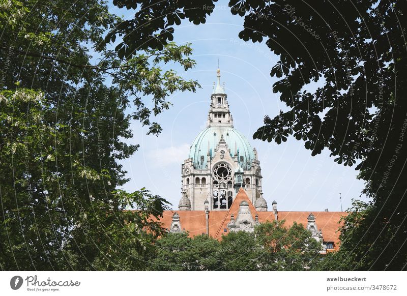 New City Hall in Hannover Germany framed by trees hannover hanover germany neues rathaus new city hall new town hall tower treetop view different perspective