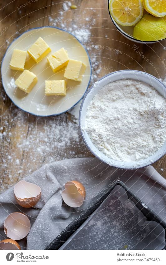 Ingredients for cake recipe on table powdered with flour ingredient butter eggs bake lemon food preparation bakery homemade making kitchen cuisine rustic dough