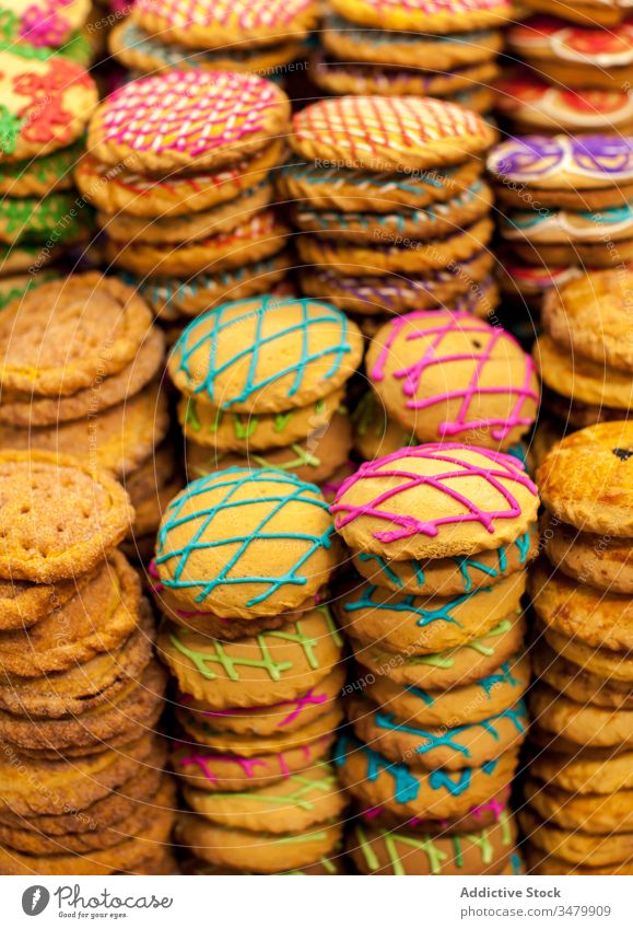 Sweet pastry with colorful icing in stacks sweet cookie decorative dessert biscuit food yummy baked treat delicious texture background tasty snack sugar