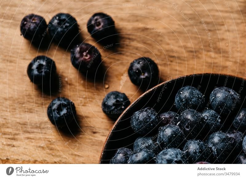 Fresh blueberries on wooden table blueberry dark food fresh bowl natural ripe delicious tasty ingredient healthy nutrition vegetarian vitamin raw meal yummy