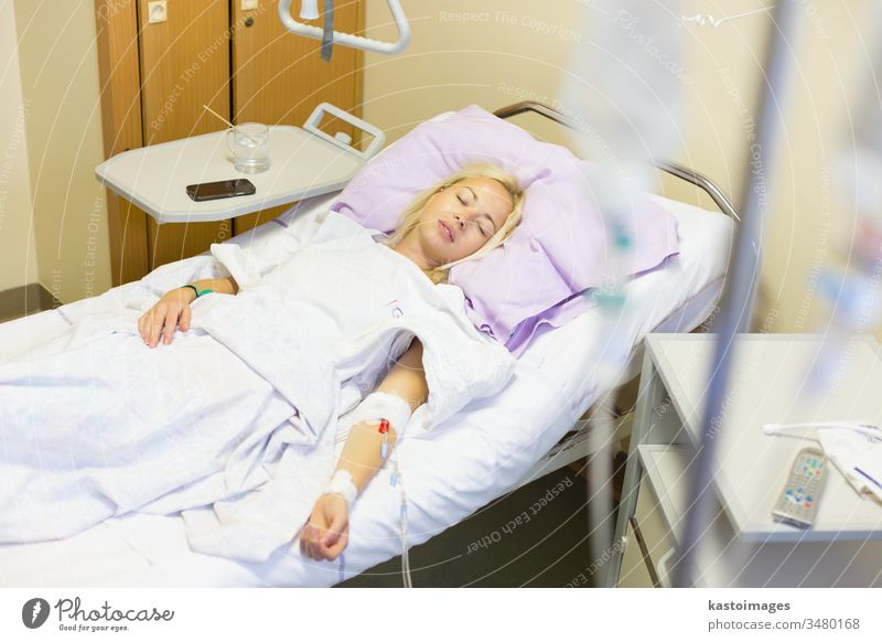 Bedridden female patient recovering after surgery in hospital care. bed sick woman healthcare medical medicine ill room recovery illness ward bedridden