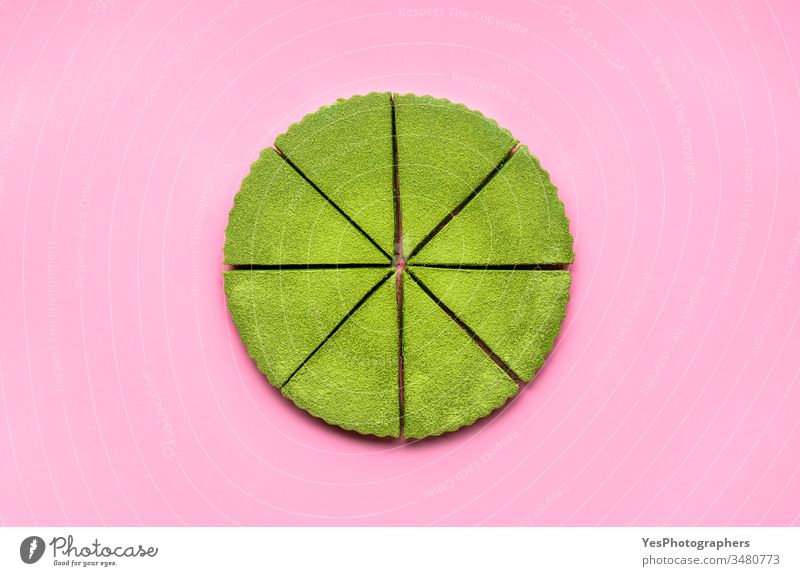 Sliced matcha cheesecake on pink background. Japanese green tea dessert above view colorful confectionery creamy cutout delicious equal portions flat lay food