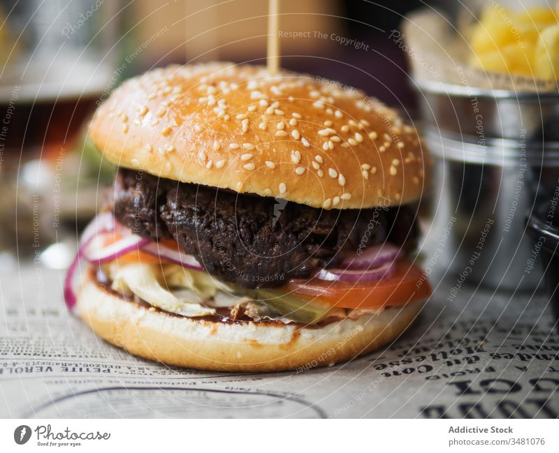 Tasty hamburger served in restaurant beef delicious fast food lunch dinner table meal meat snack cuisine tasty bun junk dish classic sesame bread appetizing
