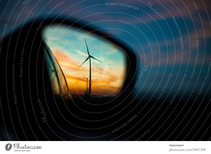 Wind turbine in the rear view mirror at sunset Wind energy plant Pinwheel Sunset Rural Side mirror Rear view mirror Mirror image Energy Energy industry