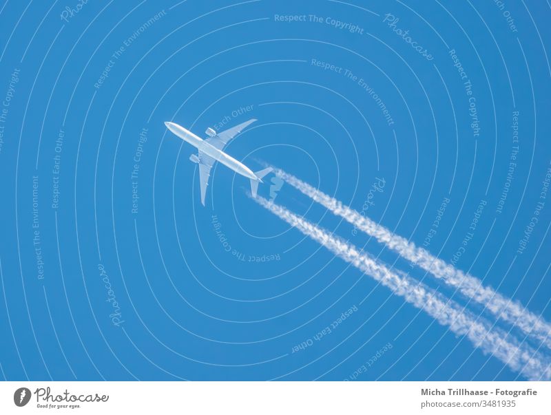 Airplane and contrails in the blue sky Vapor trail Sky Wings Engines flight travel Tourism Tourists Long distance travel Environment Climate vacation holidays