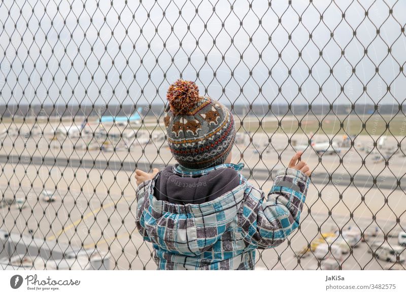 Child at the fence of the airport barrier with a view of the airport airfield Airport out vacation Airplane Fence Vacation & Travel Aviation Sky Clouds Flying