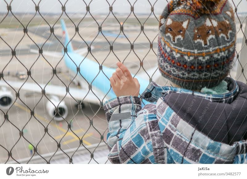 Child at the fence of the airport barrier with a view of a plane on the airfield Human being Airplane Vacation & Travel Aviation Sky Flying Exterior shot
