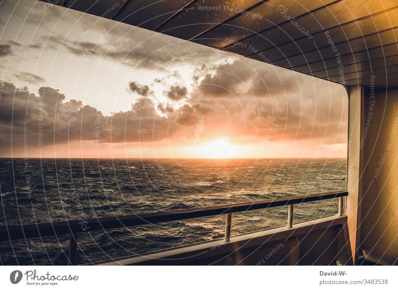 Wanderlust - riding over the waves on the deck of a ship, on the way to your next adventure, enjoying the last sunrays of the day, slowly disappearing behind the horizon.