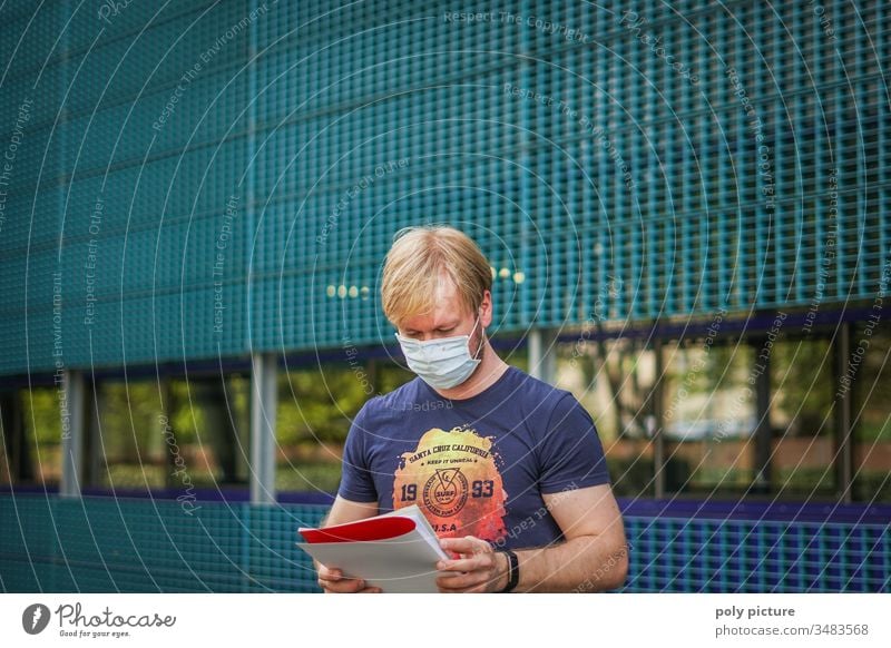 Portrait of a man with a protective mask who read a report, biological danger by coronavirus: Covid-19 danger person Epidemic Protection Virus flu