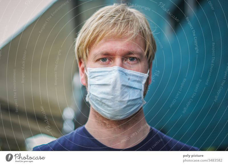 Coronavirus: danger of Covid-19. Portrait of a young man wearing a face mask, biological danger person Epidemic Protection Virus flu Environmental pollution