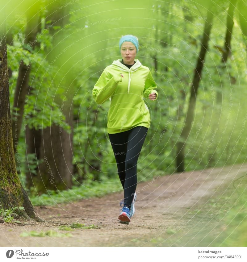 Female runner running at summer park trail . Healthy fitness woman jogging  outdoors. Stock Photo