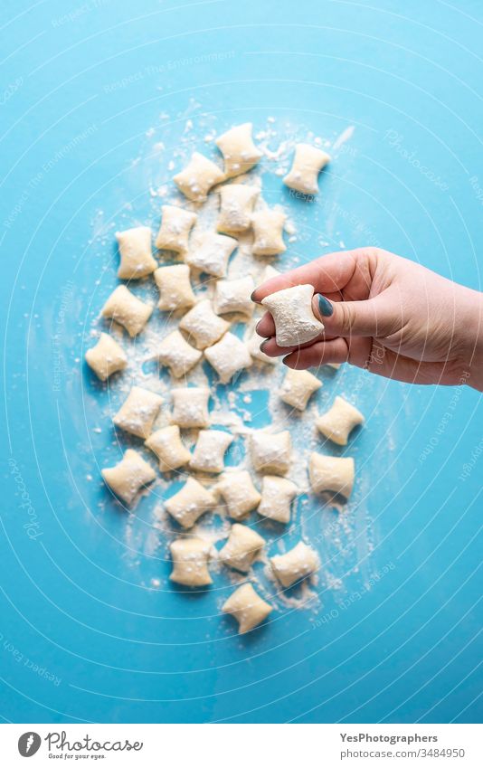 Cheese gnocchi uncooked in chef hand. Fresh gnocchi dumplings pile Italian above view blue cheese cooking cuisine diet dinner european flat lay flour food fresh